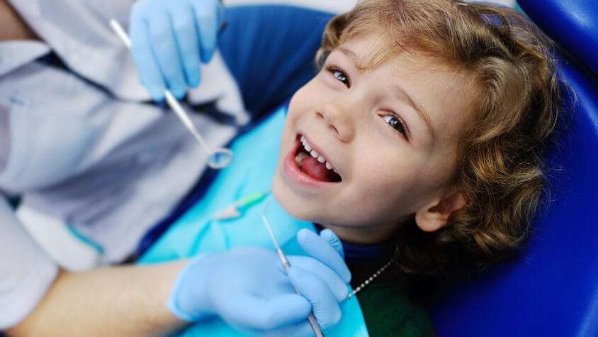 A boy receives dental treatment