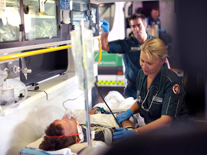 A paramedic treats a patient